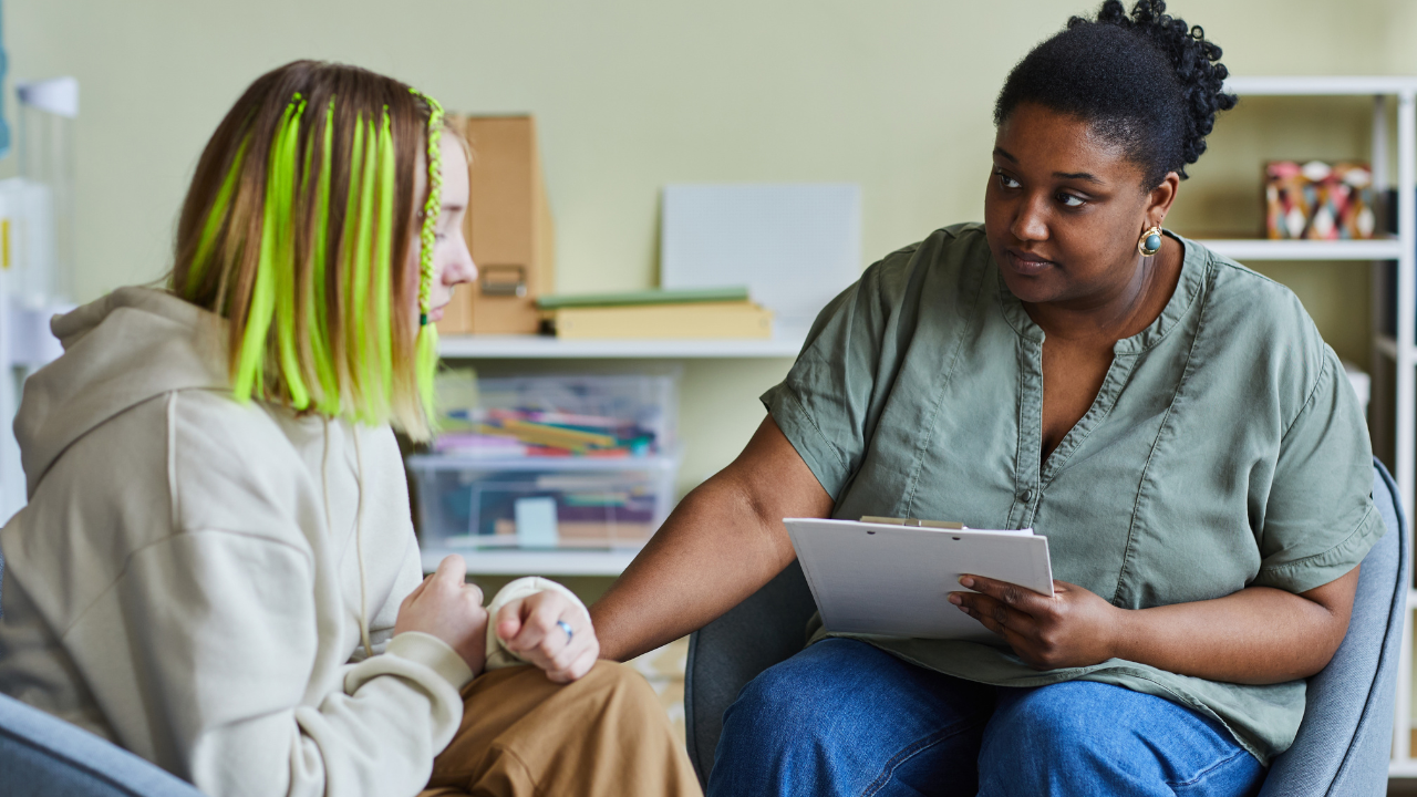 Support worker supporting young girl